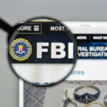 FBI Nabs 13 Chinese Sites TARGETING Americans! FBI website shown through magnifying glass.