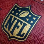 NFL Star Dead – Police Call It Homicide! Close-up of an NFL football with the logo prominently displayed
