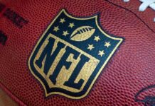 NFL Star Dead – Police Call It Homicide! Close-up of an NFL football with the logo prominently displayed