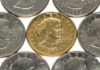 A collection of coins featuring a gold coin surrounded by silver coins
