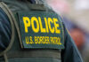 Slain Immigrant Contractor Part Of MASSIVE Fraud Ring! Police U.S. Border Patrol uniform close-up.