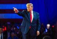 Trump Sounds Europe Alarm During Turkey Visit Person in suit pointing during a public event.
