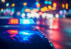 Teen ARRESTED – Terror Plot Shocks City! Police car with flashing lights at night.