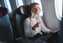 Airlines Consider ‘Adults Only’ Flights Passenger with headphones seated by airplane window