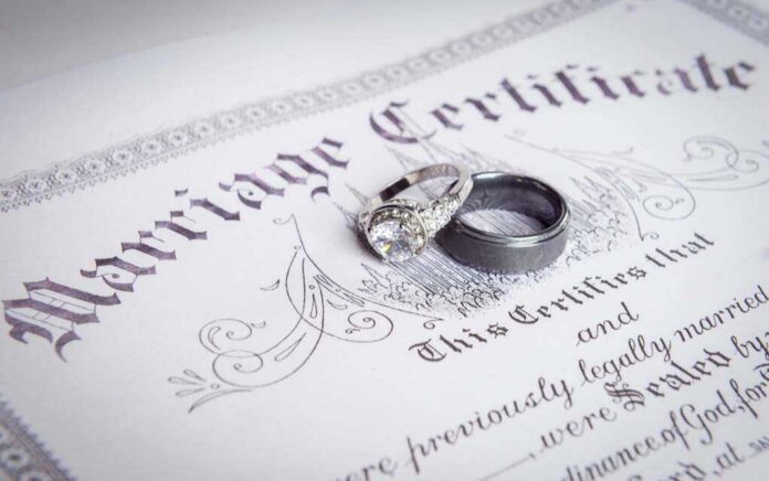 shutterstock_338597486-3- Two wedding rings resting on a marriage certificate