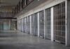 prison cell block with metal barred doors