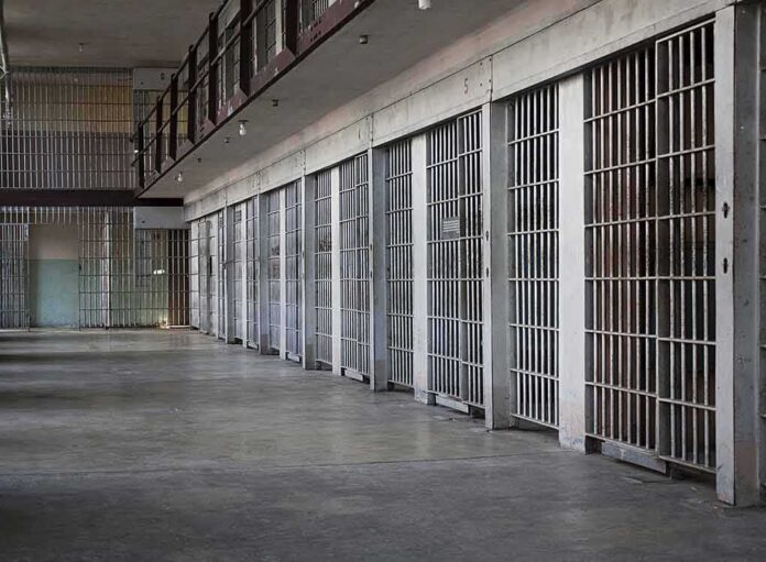 prison cell block with metal barred doors