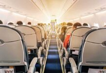 Laptop Ignites Mid-Flight — Chaos Aboard airplane cabin with passengers seated in economy class