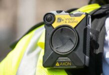 Body-worn camera attached to a high-visibility vest