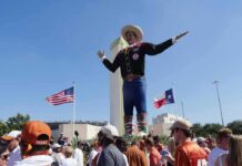 Chaos Breaks Out at State Fair As Group of Teens Beats Anyone in Sight Giant cowboy statue towers over a crowd at an outdoor event