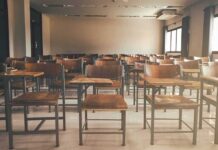 Hegseth PULLS Tenure From Military Universities Empty classroom with rows of wooden desks and chairs
