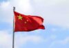 American Journalist ARRESTED In China – Thrown In Prison! Chinese national flag waving on a flagpole