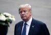 Trump Sparks Frenzy With Bizarre Makeover man in a suit with an American flag pin