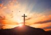 cross on a hill at sunset