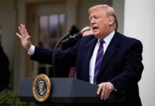 Donald Trump speaking at a podium outdoors