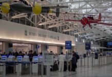 Airlines Revolt Against ICE Agents Arrests airport security checkpoint with passengers and hanging vintage airplanes
