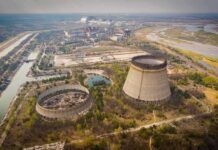 Abandoned cooling towers at a sprawling industrial site
