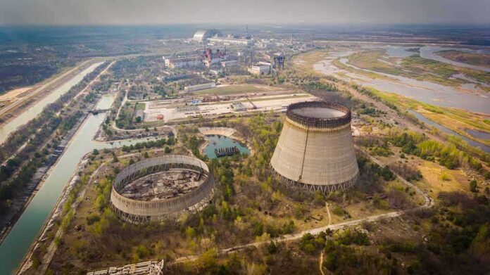shutterstock_1387140884 Abandoned cooling towers at a sprawling industrial site