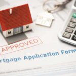 STIFFED BY OBAMA: Subcontractor Forced to Shut Down Mortgage application form with approved stamp, model house, and calculator