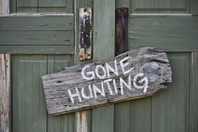 shutterstock_140754364 Weathered wooden sign on green door