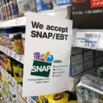 Illegals Invited to Shop on Taxpayer’s Dime Shelf sign in a grocery aisle showing SNAP EBT acceptance