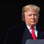Trump’s $10 Billion Battle Abruptly Ends Donald Trump at a podium with a microphone