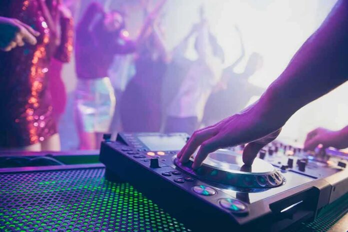 shutterstock_1552156226 DJ hand mixing on a club turntable