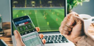 Person checking live soccer betting odds on a smartphone