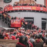 World Cup Fan Zone Turns Deadly – Fan GUNNED DOWN! Christian Jones and Teddy Williams in a large outdoor crowd at a Kansas City football rally