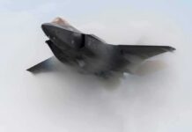 LEAKED F-35 Photo Sparks Secrecy Showdown Stealth fighter jet piercing a vapor cloud