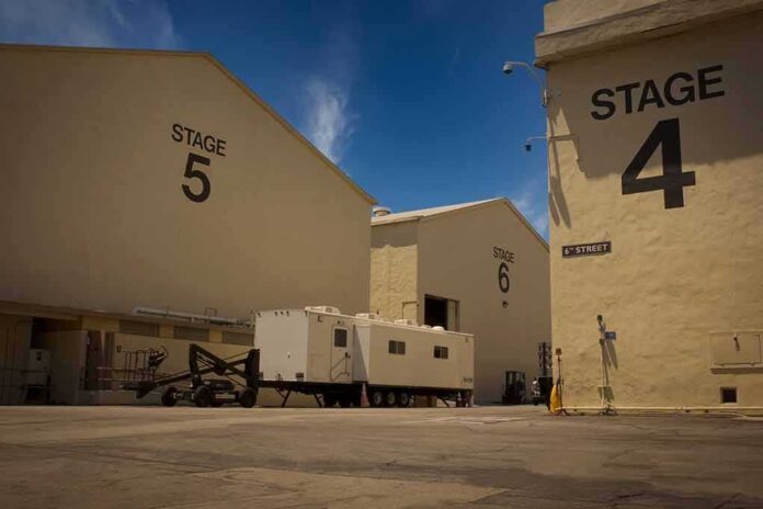 shutterstock_1928980448 Film studio stages with numbered buildings and trailer