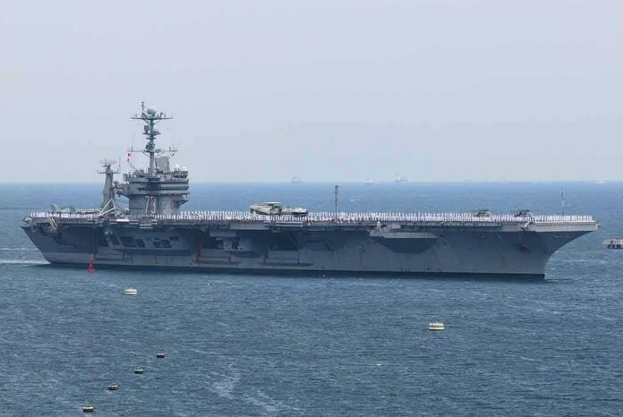 shutterstock_1984534982 Aircraft carrier sailing at sea