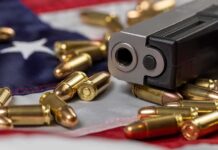 Trump Pulls Rank on DOJ in Major Guns Rights Fight Handgun with bullets on an American flag