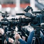 Blazing Bar Inferno Kills 27! Broadcast cameras on tripods at a press event