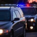 Bodycam Bombshell: NFL Star’s Arrest Explodes Police car with flashing lights behind a stopped vehicle at dusk