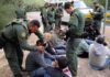 ICE Wrongly Deports Man TWICE in 6 Months Law enforcement officers process a seated group outdoors