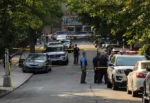 Teen Gunfire ERUPTS in Downtown Chaos Police officers secure a residential street with patrol cars and yellow tape