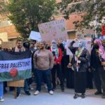 B. J. Daniels and Eugene Sims among protesters holding signs at a pro-Palestine rally