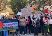 B. J. Daniels and Eugene Sims among protesters holding signs at a pro-Palestine rally