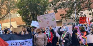 B. J. Daniels and Eugene Sims among protesters holding signs at a pro-Palestine rally