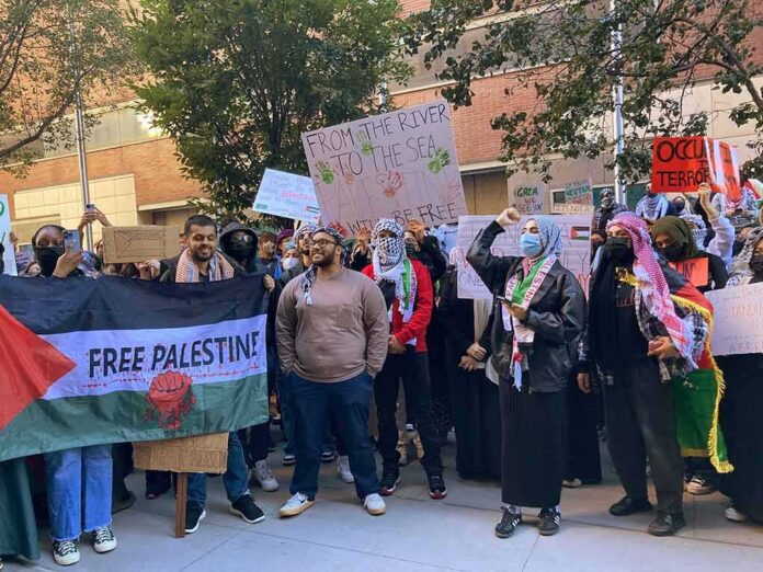 B. J. Daniels and Eugene Sims among protesters holding signs at a pro-Palestine rally