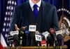 Stunning Plea: Clancy Lawyer Begs Trump On Live TV A speaker at a press conference with multiple microphones in front of them