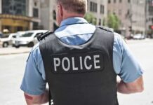 Police officer in uniform from behind on a city street