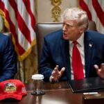 Donald Trump speaks at a meeting beside Marco Rubio at a conference table