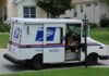 USPS mail truck parked at a suburban mailbox