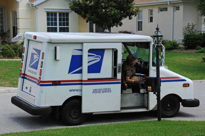USPS mail truck parked at a suburban mailbox