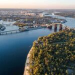 Ancient Bones Emerge As Natural Lake Vanishes Aerial view of a river city with bridges and green islands