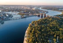 Ancient Bones Emerge As Natural Lake Vanishes Aerial view of a river city with bridges and green islands