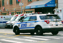 Killer Father’s Hospital Confession Stuns Cops Police car and ambulances outside emergency room entrance.