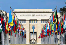 U.N. MELEE Ends With Diplomat Kicked Out United Nations building with numerous national flags outside.